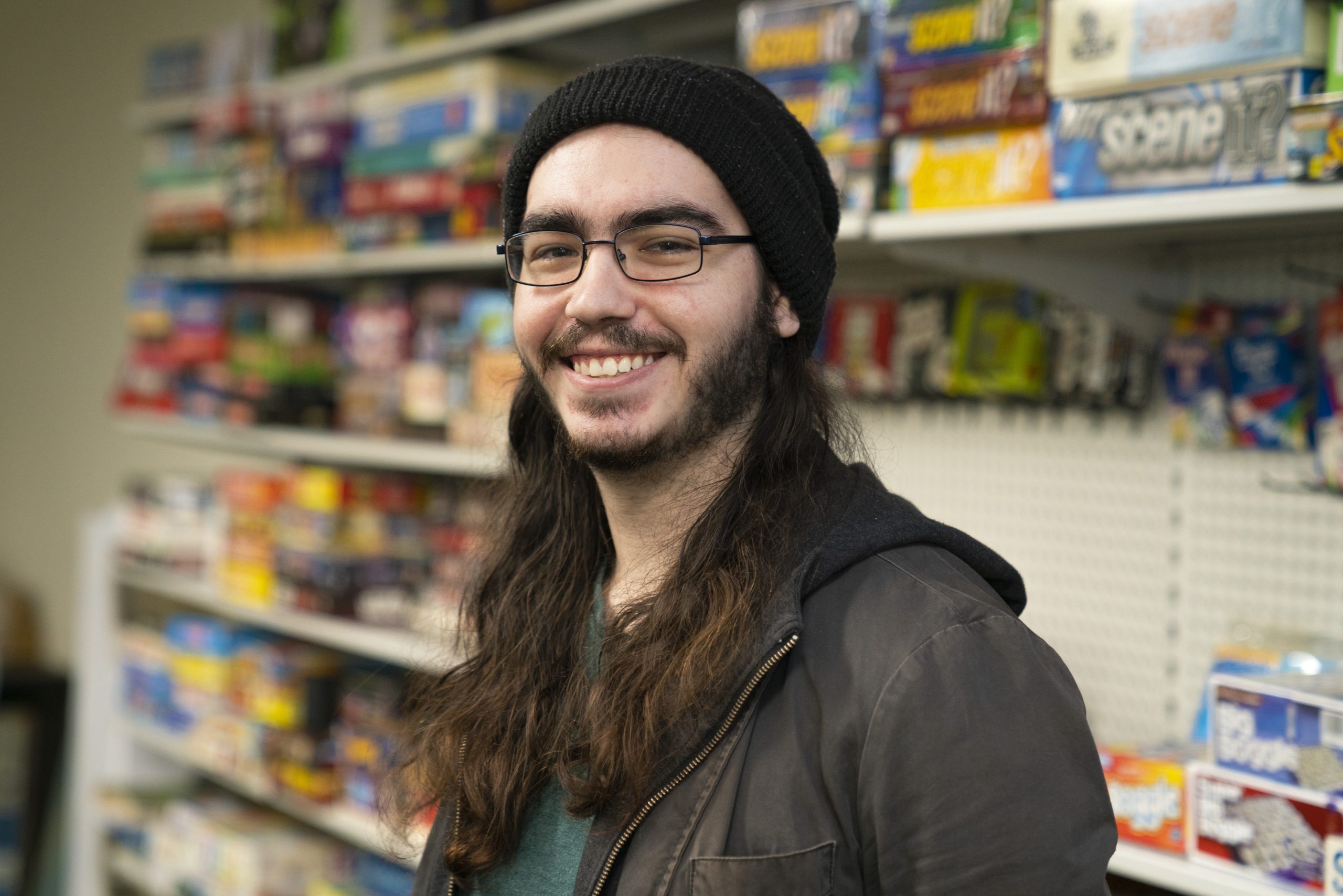 Lachlan smiling towards the camera with shelving behind