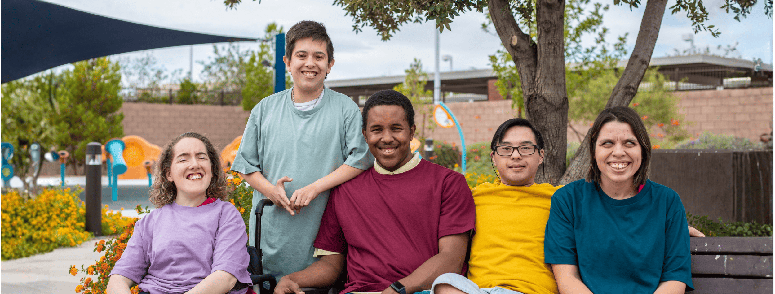 Group of people with disability sitting on a park bench